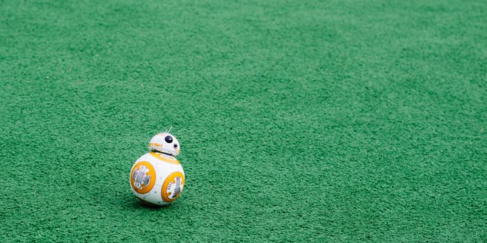BB-8 Robot from the film Star Wars: The Force Awakens moving across a green carpet.