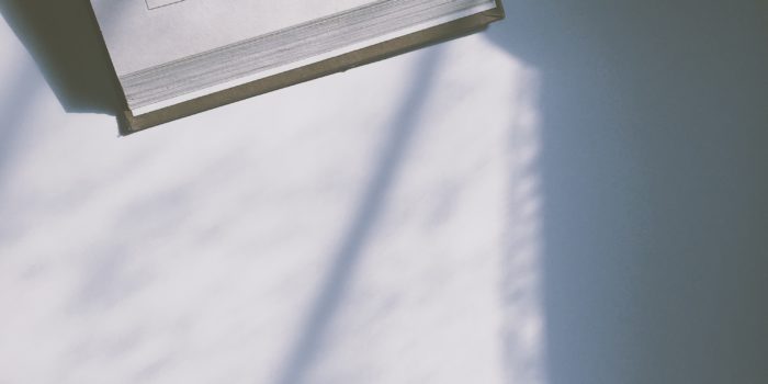 A hardback book open at a page that says "adventures... and lessons learned."