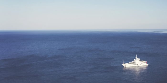 A cruise liner heading towards a tiny rowing boat.