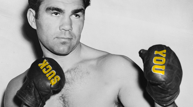 A boxer with the words "you" and "suck" on his gloves.